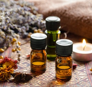 essential oils with candle and herbs